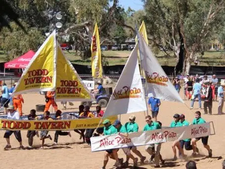 Peaple carrying mock boats at the Henley-on-Todd Regatta